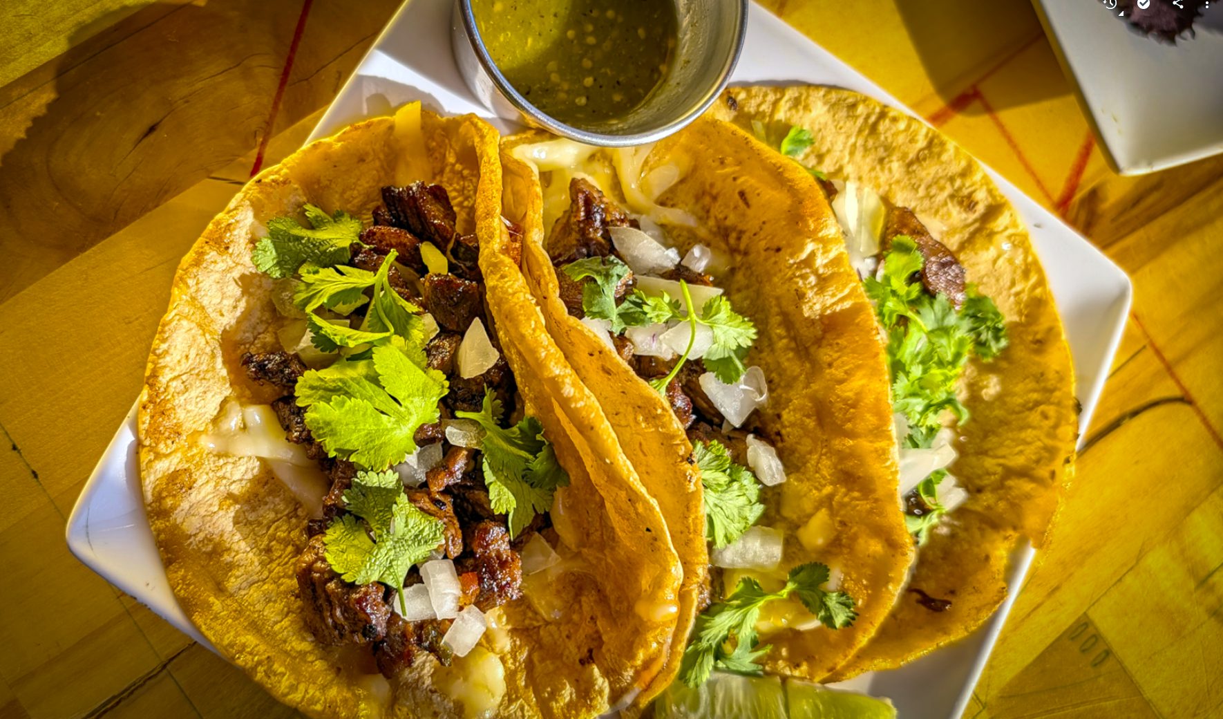 Steak street tacos with salsa verde at Estrella Negra